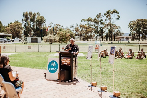 Stan Grant standing at a pedestal taking part in the naming ceremony of the CSIRO Parkes Wiradjuri telescopes. 