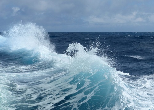 White caps of a breaking wave from the side of the Australian Marine National Facility research vessel (vessel not shown) with calmer ocean view in the background.