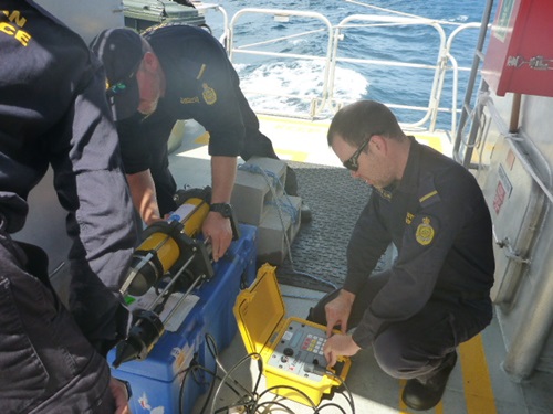 Border Force working with hydrophone technology on a boat. 