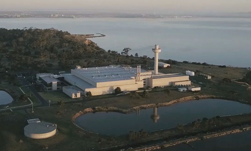 Looking towards the Australian Centre for Disease Preparedness (ACDP) building across bushland and a lake. 