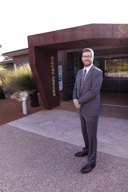 Director standing in front of building