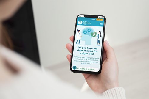 Mockup of a woman holding an iphone 11 pro in portrait position with TWD diet quiz app running. 