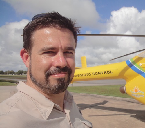Dr Brendan Trewin with a yellow helicopter