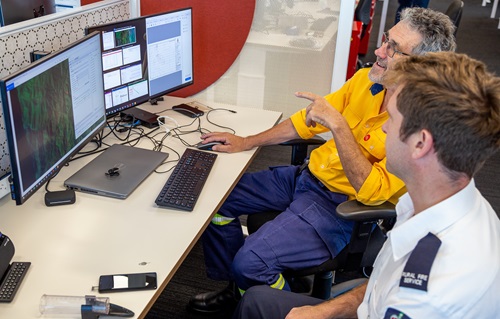 Supervisor, Fire Behaviour Analysis, David Field (closest to camera) and Fire Behaviour Training Coordinator Geoff Goldrick (rear) running bushfire models at the NSW RFS Headquarters, Sydney Olympic Park. Image by NSW RFS.