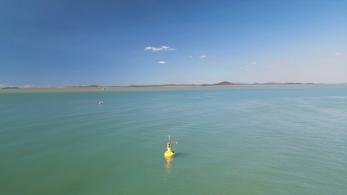 HydraSpectra water sensor mounted on a buoy on Darumbal Sea Country in Keppel Bay, with brown sediment plume in the background. 
