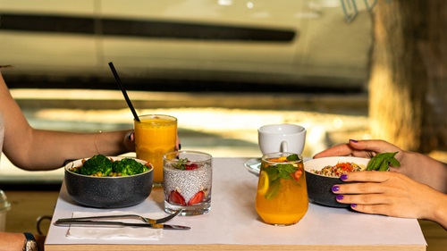 Two people at a table eating a healthy lunch