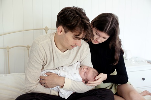 Couple cradling new-born baby