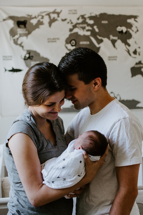 Couple holding new-born baby