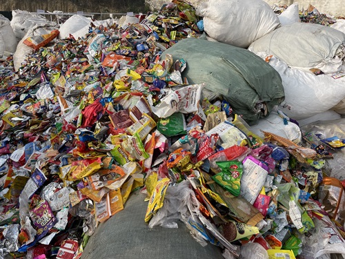 Multilayer plastic packaging waste at a collection facility.