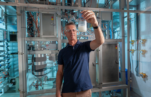 CSIRO Senior Experimental scientist Philip Hazewinkel in the Perth CSIRO Labs with a sample of Fischer-Tropsch wax - a standby jet fuel pre-cursor for an approved sustainable aviation fuel