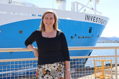 Assoc Prof Helen Phillips standing in front of the Research Vessel Investigator.