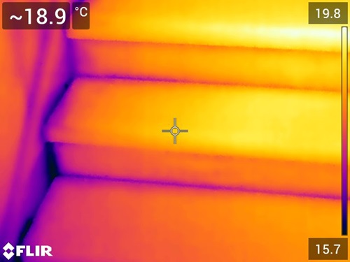 Infrared image of a staircase that shows where cold air is seeping through. 