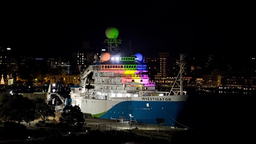 RV Investigator lit up in the colours of pride in her home port of Hobart.