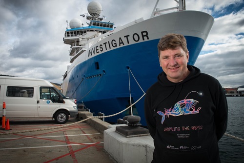 Dr Tim O’Hara standing in front of CSIRO research vessel Investigator. 
