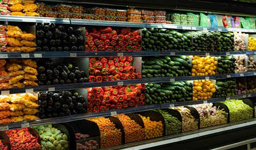 A display in a grocery store filled with lots of fruits and vegetables.