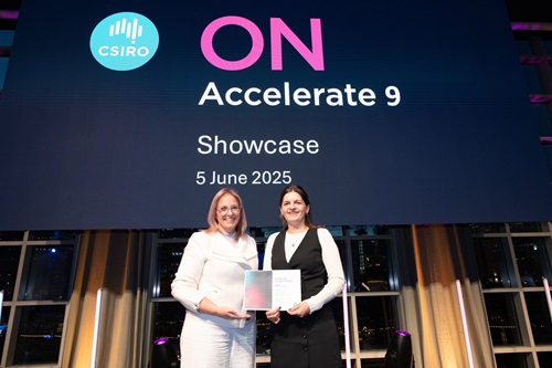 Two people on stage in front of large sign saying ON Accelerate Showcase 5 June 2025
