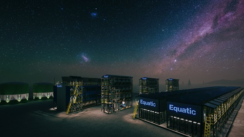Nightscape view of electrolysis plant including two large building with the name 'Equatic' lit up
