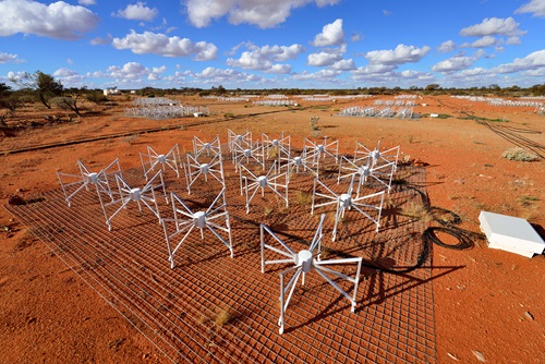 Antennas from the MWA telescope in the outback on orange soil. 