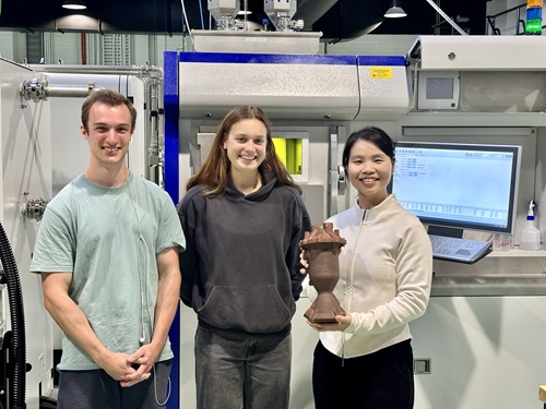 University of Melbourne students and Stuart Davis and Brooke Doolan with CSIRO's Dr Cherry Chen holding the rocket engine.