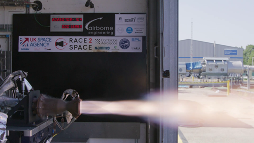 Slinky, the 3D-printed rocket engine, under hot firing test with a burst of flame projecting from the rocket