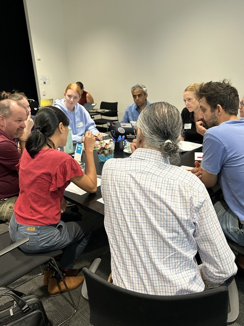 Participants at a seminar around a table in discussion