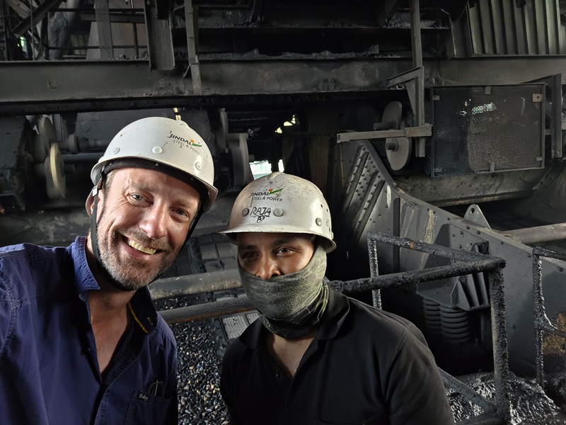 Two men in hard hats smiling