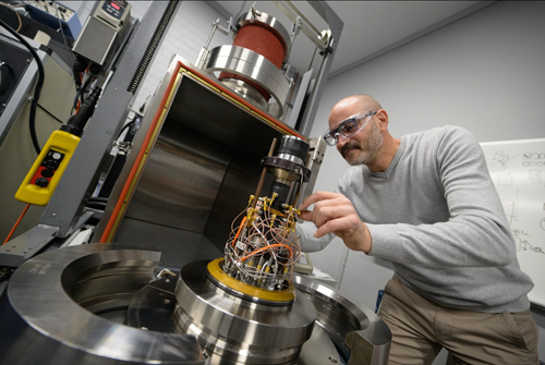 Close up of Dr Joel Sarout working with machinery