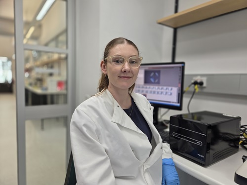 Dr Caitlin Johnston sitting in the lab 