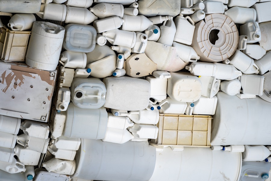 Pile of plastic waste containers neatly stacked together. 