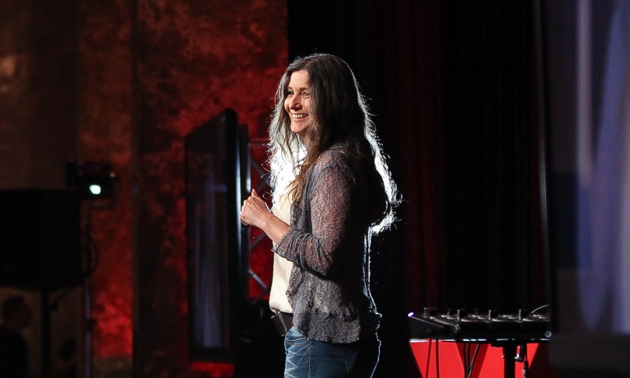 Woman standing on a stage smiling