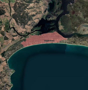 A satellite image of Dolphin Sands, Tasmania. An area is shaded is pink to show bushfire extent for December 2025.