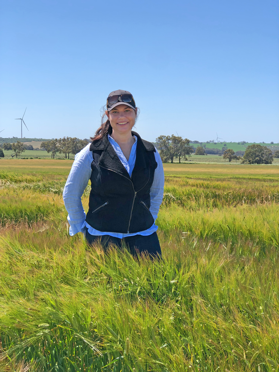 Student standing in a wheat field