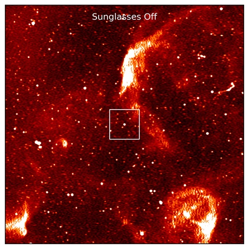 A speckled field of red and white, with a bright dot in the centre, highlighted by a square. Text reads "Sunglasses Off"