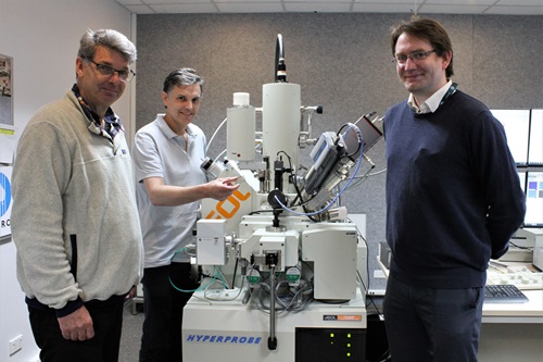 CSIRO researchers Mr Colin MacRae (left), Dr Nick Wilson (middle), and Mr Aaron Torpy (right) stand with CSIRO's flagship electron microprobe analyser (EPMA).