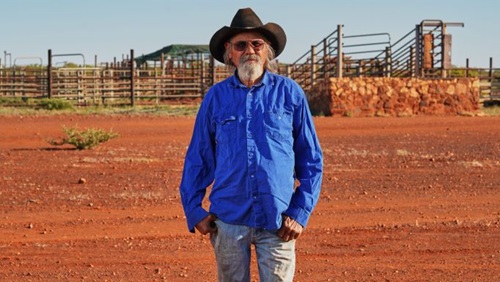Image of Trevor Parker, Senior Custodian of Peedamulla Station in front of cattle yards.  