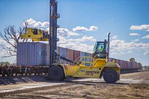 A truck loading cargo onto trains at  Narrabri Freight Hub.  Image courtesy of Department of Infrastructure, Transport, Regional Development and Communications. 