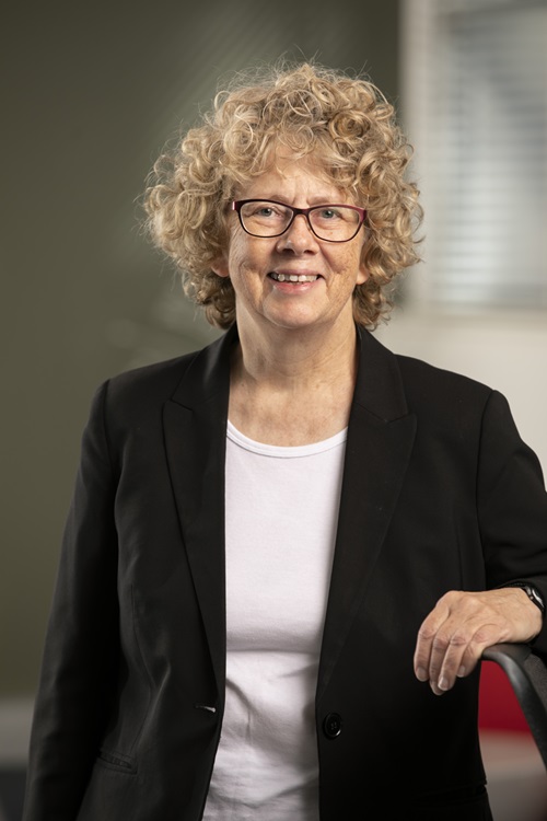 Woman in white shirt and black blazer