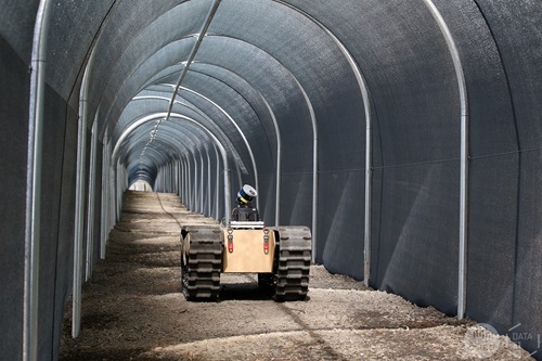 A robotic truck moves through a tunnel