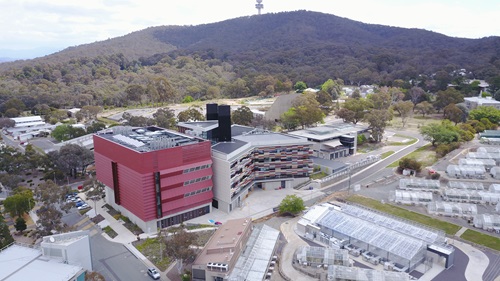 Aerial image of a building in front of a hill