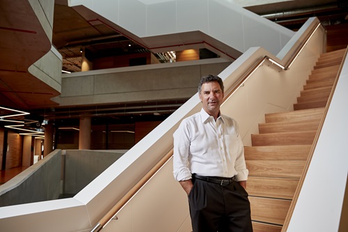Dr Marshall stands in front of a staircase