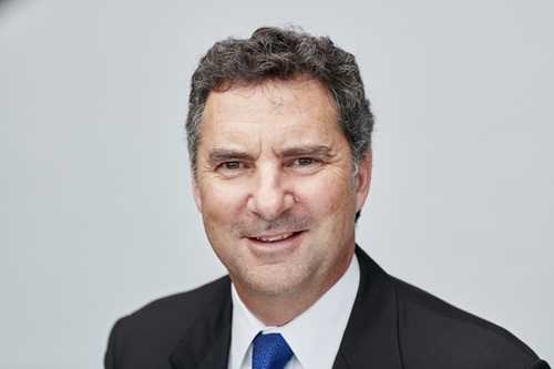 Headshot of Dr Larry Marshall in front of a grey wall