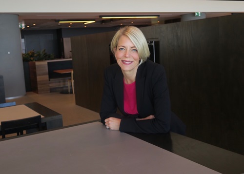 Kirsten sits at a desk