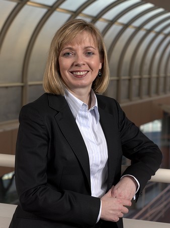Headshot of Toni Moate in front of curved roof