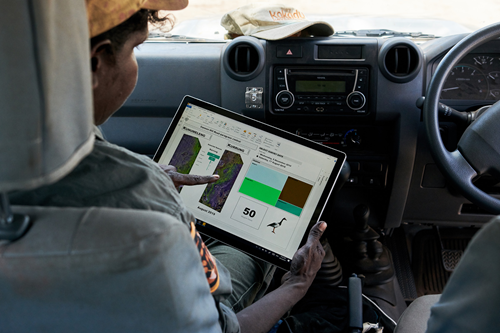 Person sitting in car using electronic dashboard