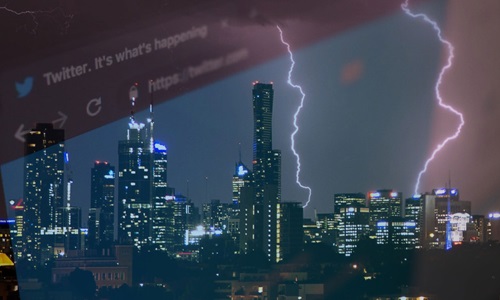 View of lightning stiking city buildings through a high rise window. 