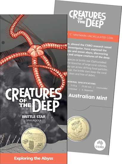A pamphlet showing a red brittle star, as well as a gold coin.