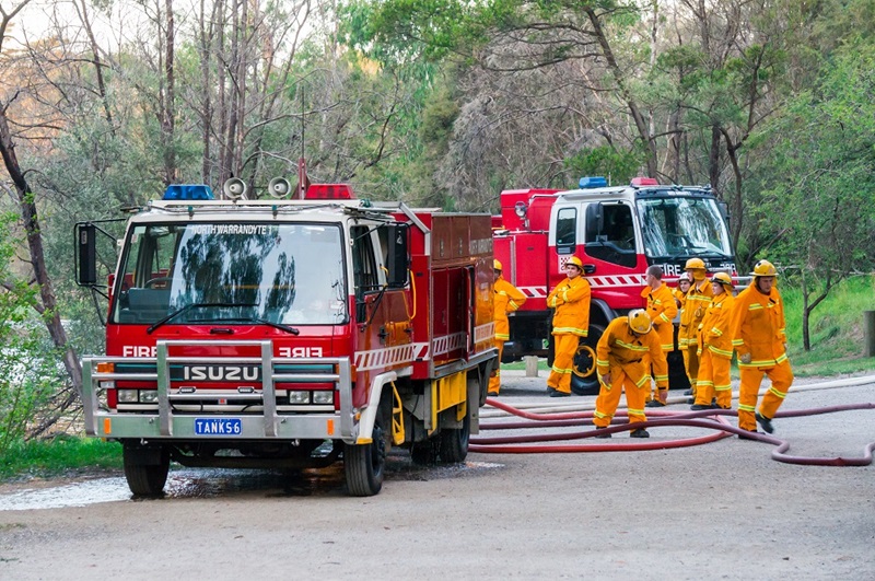 Volunteer fire fighters from the North Warrandyte brigade of the Country Fire Authority practicing by the Yarra River in Warrandyte, with Isuzu fire trucks in 2015. These trucks have been fitted with crew protection from burnovers.