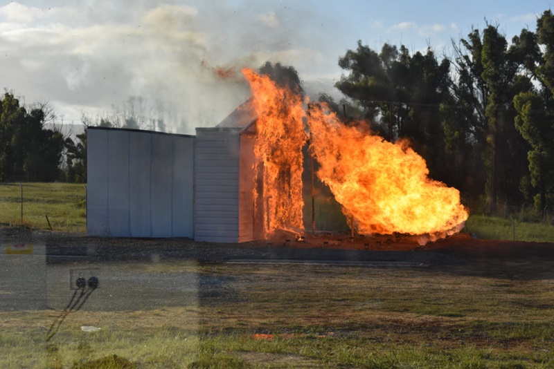 Image of a burnover experiment conducted by Justin Leonard where the house is beginning to ignite.