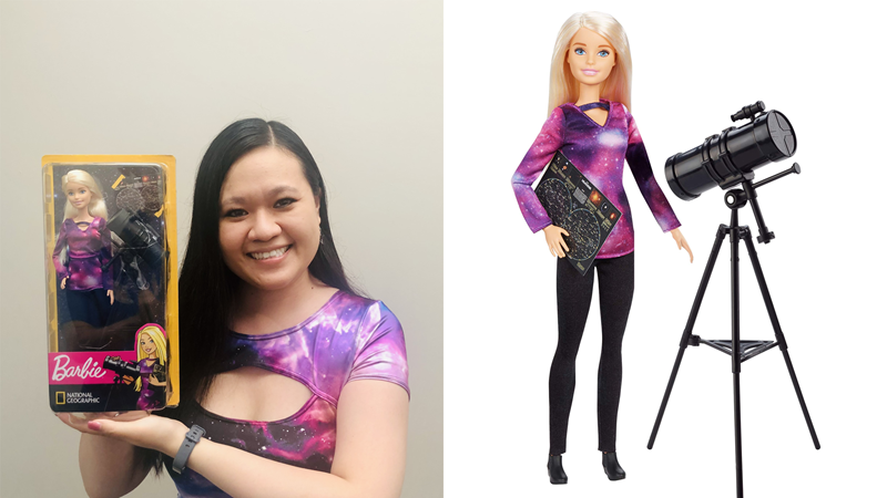 Photo of a woman (Dr Karen Lee-Waddell) smiling and holding the Astrophysicist Barbie.