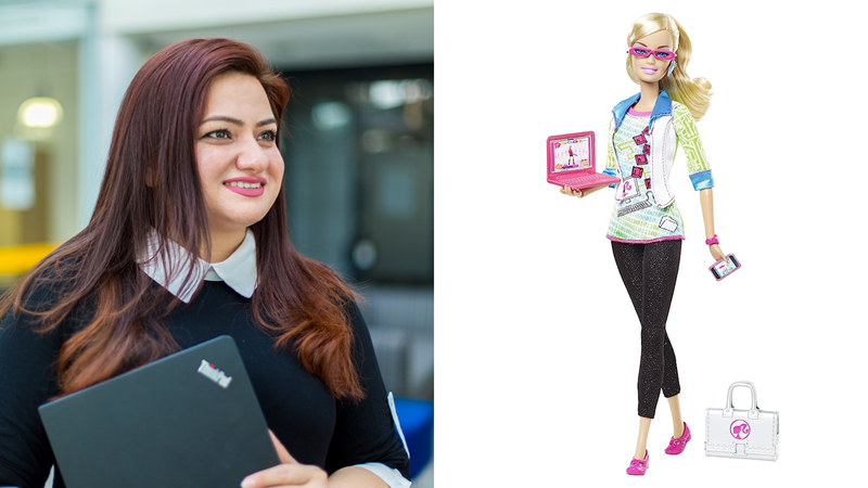 Photo of a woman (Muneera Bano) holding a laptop, smiling, next to the Computer Engineer Barbie.
